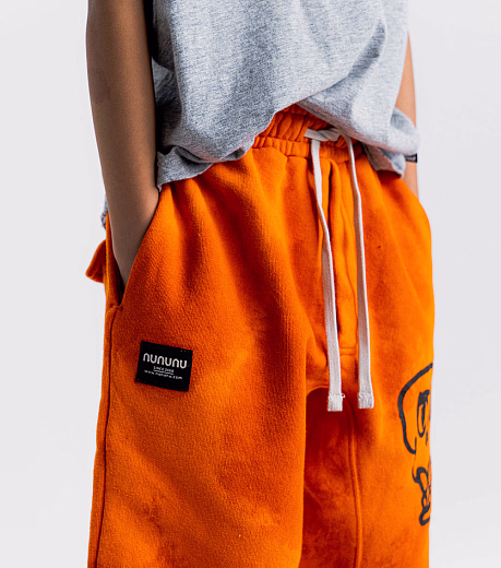 Джоггеры KOOKY SKULL ORANGE SUN от бренда NuNuNu