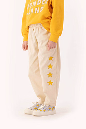 Брюки молочного цвета со звездами от бренда Tinycottons