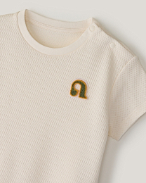 Комплект футболка и ползунки в молочном цвете от бренда Anna Leon